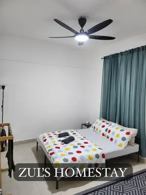 a bedroom with a bed with a ceiling fan at Zuls Apartment Homestay Cameron Highlands in Tanah Rata
