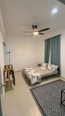 a bedroom with a bed and a ceiling fan at Zuls Apartment Homestay Cameron Highlands in Tanah Rata