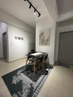 a dining room with a table and a rug at Zuls Apartment Homestay Cameron Highlands in Tanah Rata