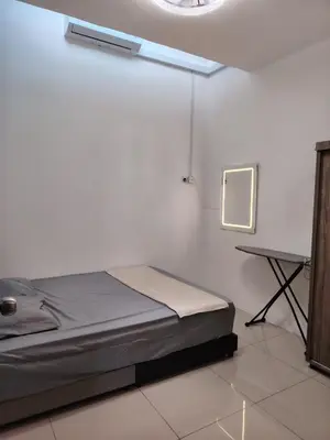 a room with a bed and a desk in it at FH Homestay Kuala Lipis 3R2B in Kuala Lipis