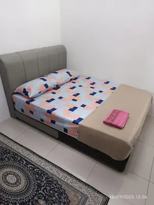 a bed in a room with a bedvisor with at FH Homestay Kuala Lipis 3R2B in Kuala Lipis