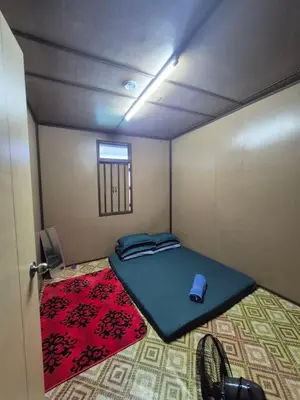 a small room with a bed and a window at Homestay Sayang Salmah in Balik Pulau
