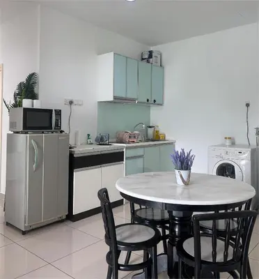 a kitchen with a table and chairs and a refrigerator at Georgetown 2R1B Gleneagle Gurney City Sea view in George Town