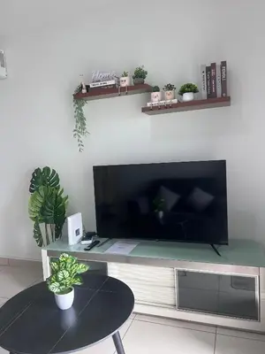a living room with a large flat screen tv at Georgetown 2R1B Gleneagle Gurney City Sea view in George Town