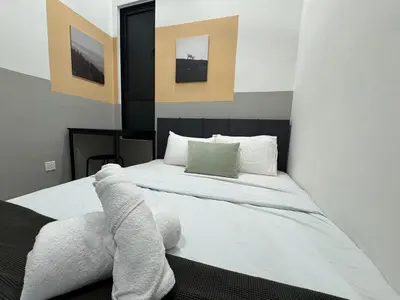 a bedroom with a bed with white sheets and pillows at Simple Stay Aston Acacia Bukit Mertajam in Bukit Mertajam