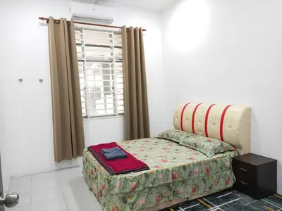 a living room with a couch and a window at Hannan Homestay in Kuala Lipis