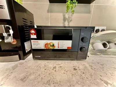a microwave sitting on top of a counter at ICC Luxury Suites by Grab A Stay in Ipoh