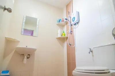 a bathroom with a shower and a toilet and a sink at Lavender Home in Sekincan