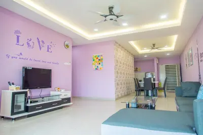 a living room with a couch and a tv at Lavender Home in Sekincan