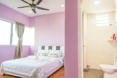 a purple bedroom with a bed and a ceiling fan at Lavender Home in Sekincan