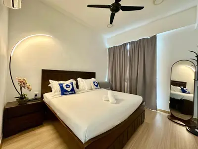 a bedroom with a large bed with a ceiling fan at New Reno Jazz Suite 2 bedroomsSeaviewKaraoke in Tanjong Tokong