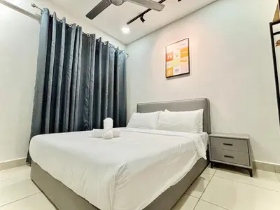 a bedroom with a bed with white sheets and blue curtains at Majestic Condo Ipoh Central by PLY Home in Ipoh