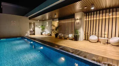 a swimming pool in a building with a pool at Hotel Warisan in Taiping