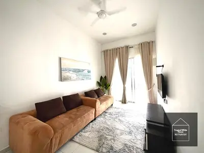 a living room with a brown couch in front of a window at Homestay Meru Ipoh Mus Lim Only Tropical White House in Ipoh