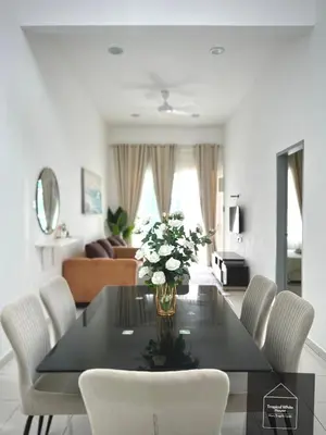 a dining room table with white chairs and flowers on it at Homestay Meru Ipoh Mus Lim Only Tropical White House in Ipoh