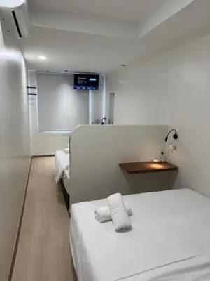 a hospital room with a bed with two towels on it at LM Homestay in Kulim
