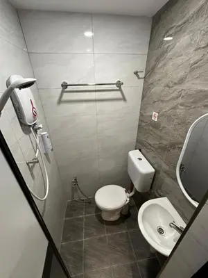 a bathroom with a toilet and a sink at LM Homestay in Kulim
