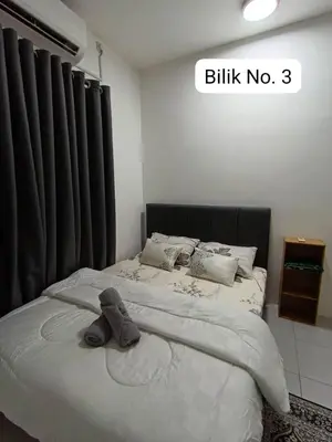 a bed with a stuffed animal on top of it at Homestay AinulZahra- For Malays Only in Seri Iskandar