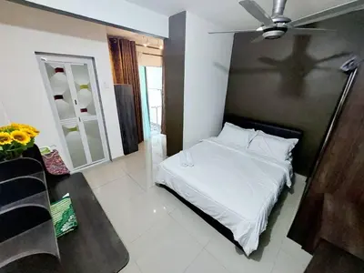 a bedroom with a bed with a cross on the wall at fz north silibin in Ipoh