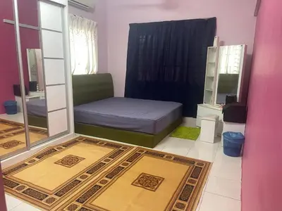 a living room with a couch and a mirror at ZzHomestay