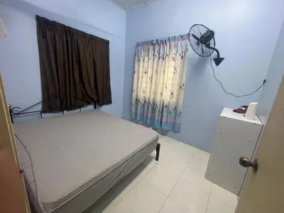 a bedroom with a bed and a window with a fan at ZzHomestay