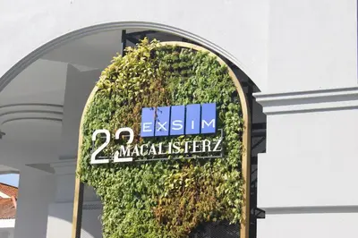 a sign on a building with a green wall at SkyPool at 22Macalisterz - Georgetown City Centre, 4pax by PG Home in George Town