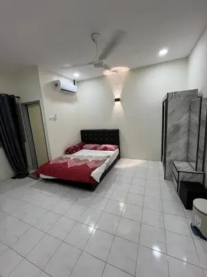 a bedroom with a bed in the corner of a room at KMK Homestay in Sungai Petani