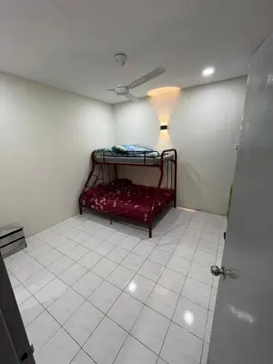 a room with a red bed with a lamp on it at KMK Homestay in Sungai Petani