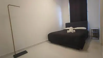 a bedroom with a bed with a teddy bear on it at Tranquility Grove The Italian Modern Condo in Ipoh in Ipoh