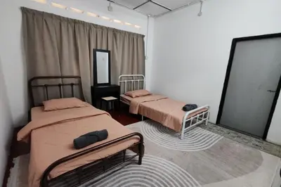 a bedroom with two beds and a mirror at DRH Villa in Ipoh