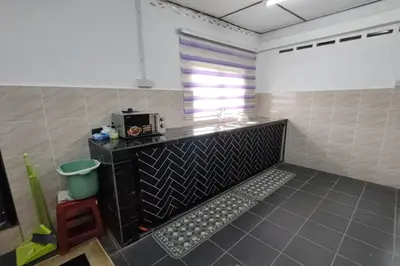 a kitchen with a counter and a microwave in a room at DRH Villa in Ipoh