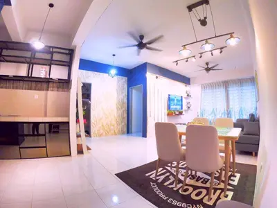 a living room and kitchen with a table and chairs at HomeStay Amer in Ipoh