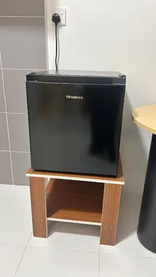 a television sitting on top of a wooden stand at StudioMimi Near UTP UiTM Seri Iskandar in Seri Iskandar