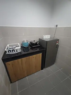 a small kitchen with a stove and a refrigerator at CAMERON HIGHLAND CENRTUM BRINCHANG Homestay By Dcozy 6-7pax in Brinchang