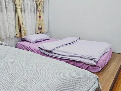 two beds sitting on the floor in a room at Warm Nest Condo 9\u697c\u6e29\u99a8\u5c0f\u5c4b in Sekincan
