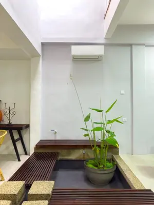 a living room with a bench and a plant at Gracious Green Gurney in George Town