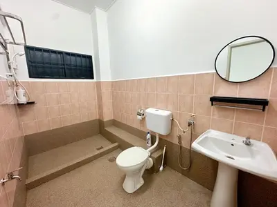 a bathroom with a toilet and a sink and a mirror at POP Stay \u6cca\u5c45 Sungai Bakap Jawi in Kampong Gurun