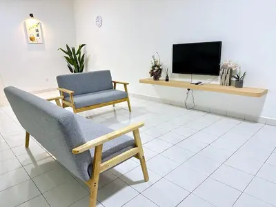 a living room with a chair and a television at POP Stay \u6cca\u5c45 Sungai Bakap Jawi in Kampong Gurun