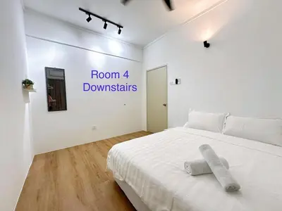 a bedroom with a white bed and a sign that reads room downstairs at POP Stay \u6cca\u5c45 Sungai Bakap Jawi in Kampong Gurun