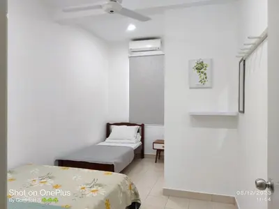 a room with two beds and a ceiling fan at Leisure Homestay BM in Bukit Mertajam