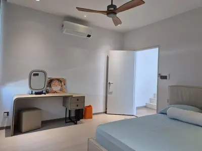 a bedroom with a bed and a desk and a ceiling fan at Mega Seaview Escape - Butterworth Penang in Butterworth