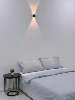a bedroom with a bed with a light above it at Maple Home BM in Bukit Mertajam