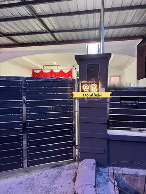 a garage with two sets of gates and a stove at Pantai Remis 116 Minsu Homestay in Pantai Remis