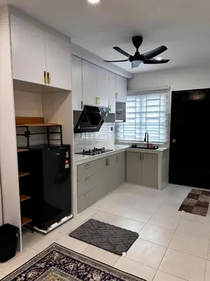 a kitchen with a black refrigerator and white cabinets at Teratak MakTeh in Kampong Ayer Melintas Besar