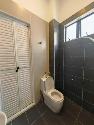 a bathroom with a toilet and a window at Ipoh M Villa in Ipoh