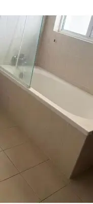 a white bath tub in a bathroom with a window at Deluxe Apartment CintaSayang Resort in Sungai Petani