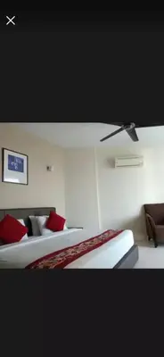 a hotel room with two beds and a ceiling fan at Deluxe Apartment CintaSayang Resort in Sungai Petani
