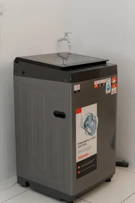 a washing machine with a sink on top of it at VibeHaus Snooker SimpangAmpat ``` 4Room10Pax3Bath in Simpang Ampat