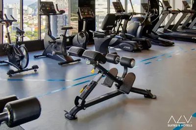 a gym with several treadmills and exercise bikes at 22 Macalisterz's Armoire Collection by ALV in George Town