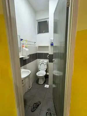 a bathroom with a toilet and a sink at AYAAN MUSLIMAH Home at Tanah Rata in Tanah Rata